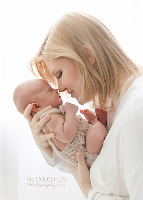 newborn photography mother holding her baby touching noses