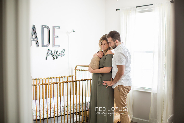 home newborn session parents in the baby nursery