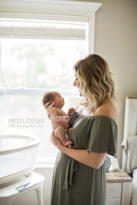 home newborn session mom gazing at her baby with love