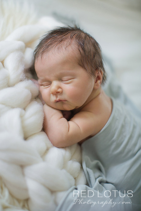 home newborn session baby sleeping on the bed