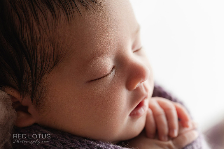newborn baby close up photo of face and eyelashes