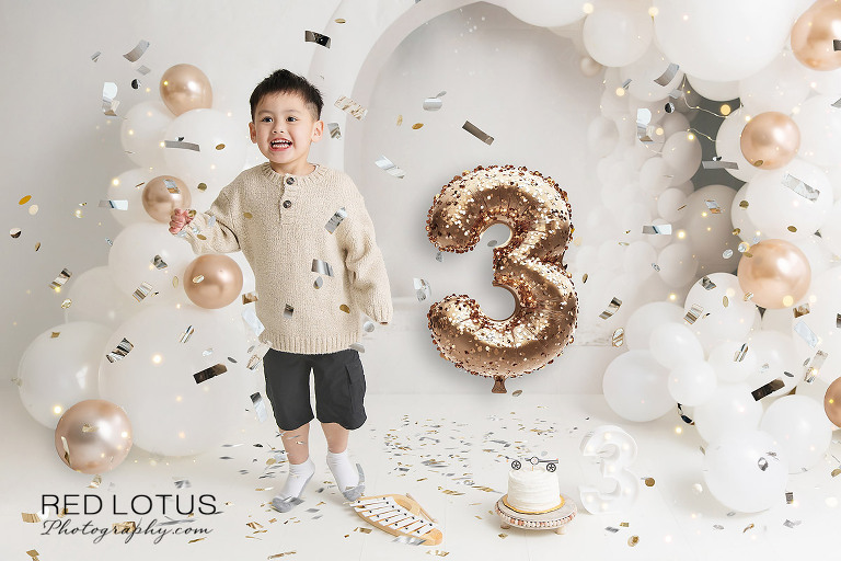 three year old cake smash milestone photo boy with confetti balloons