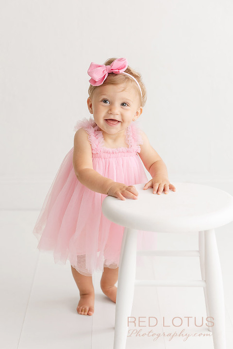 one year old girl photo session girl in pink dress