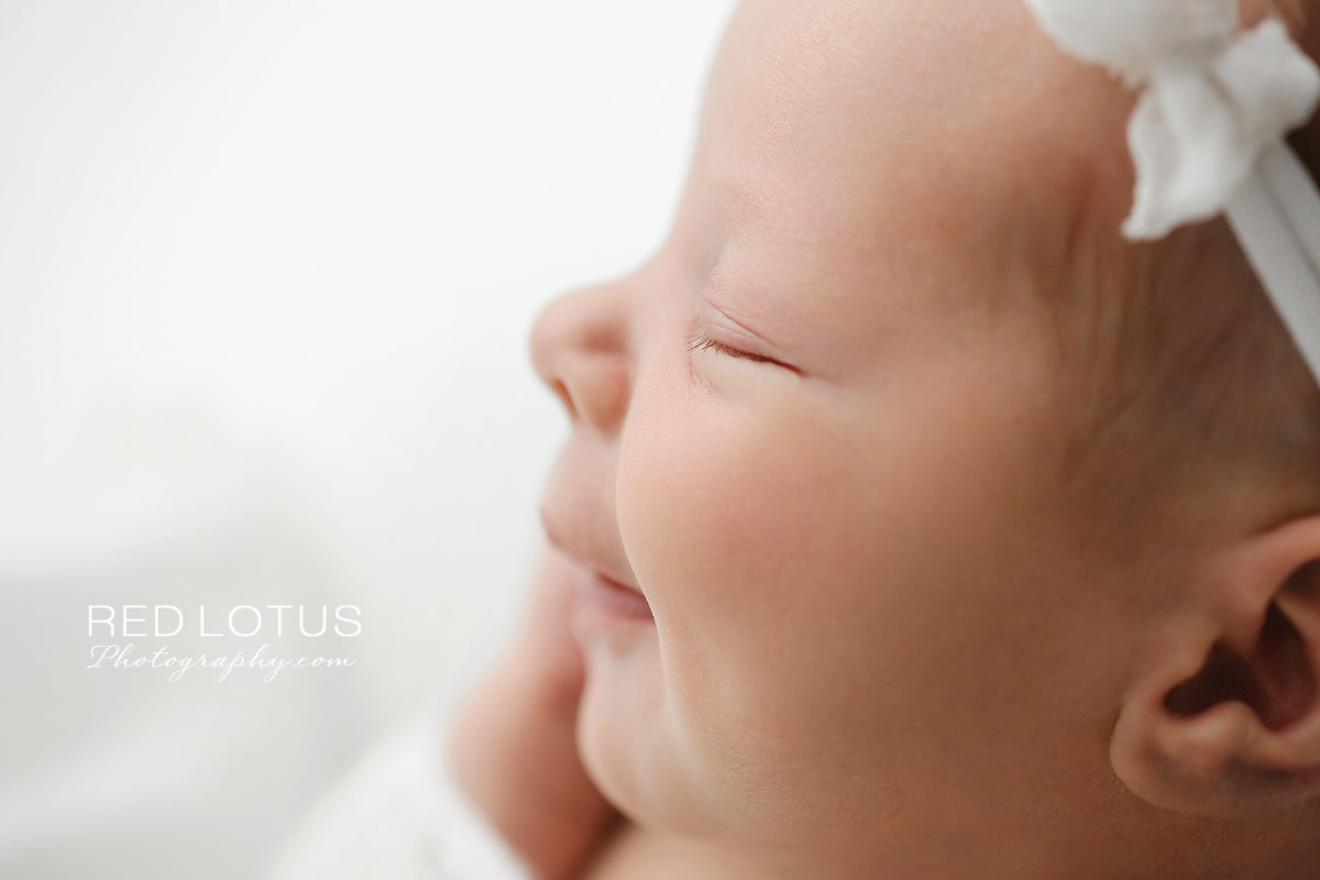 newborn baby profile smiling