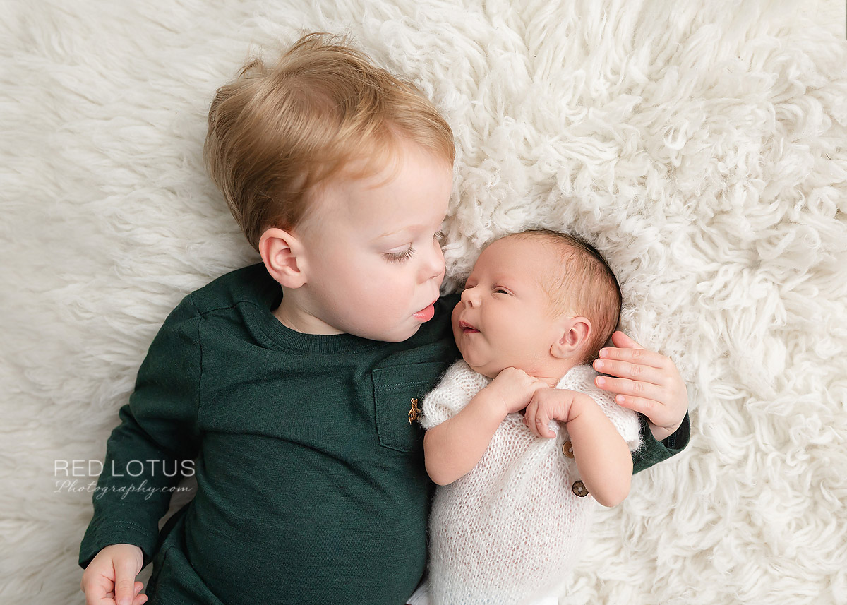 newborn baby with toddler sibling
