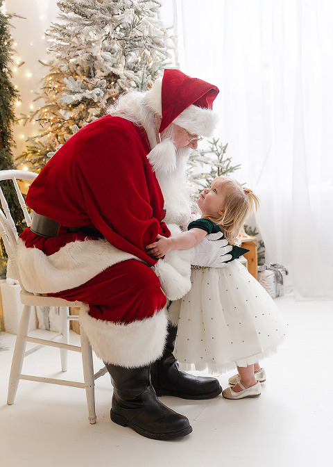 Santa picking up little girl